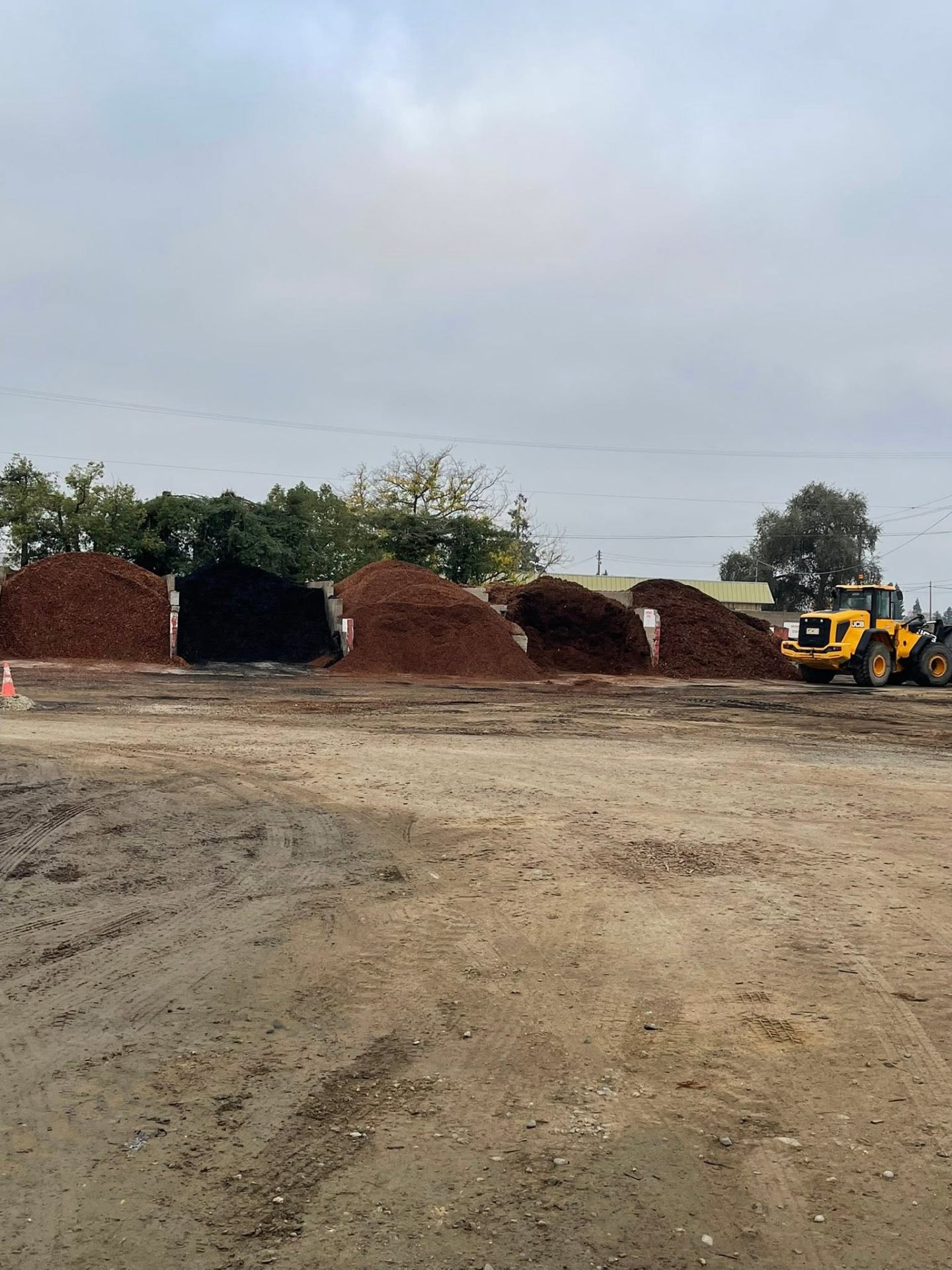 Mulch piles being loaded with a JCB wheel loader